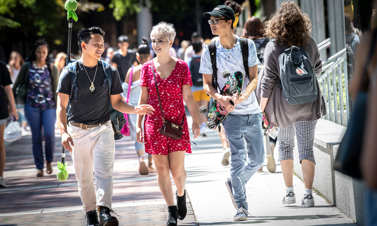 A group of students walking on the sidewalk