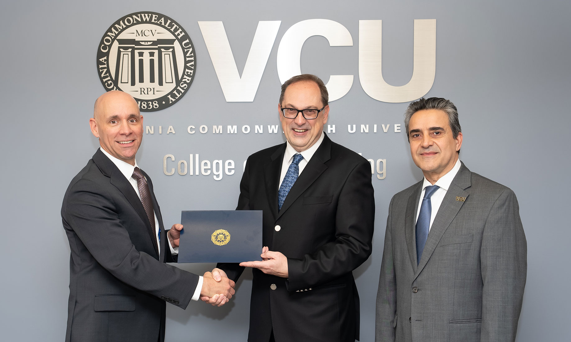 Milos Manic, Ph.D., computer science professor, (center) with Stanley M. Meador, special agent in charge of the FBI Richmond Field Office, (left) and Azim Eskandarian, D.Sc., the Alice T. and William H. Goodwin Jr. Dean of the VCU College of Engineering (right)