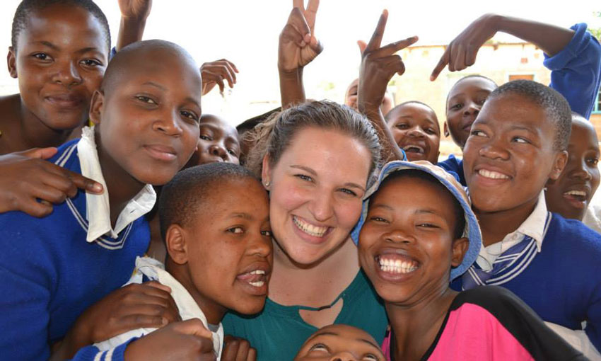 Mary Knipper with a bunch of children in Lesotho.